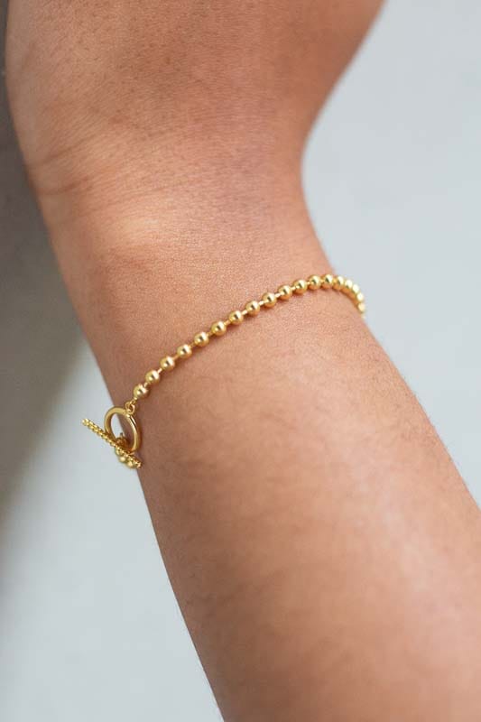 woman wearing 18k gold plated sterling silver ball bead chain lariat bracelet