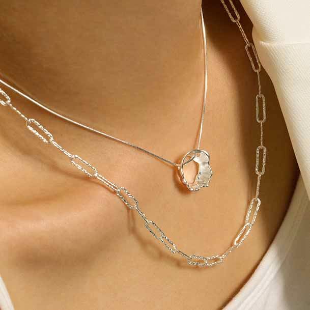 woman wearing diamond cut wide link sterling silver chain necklace