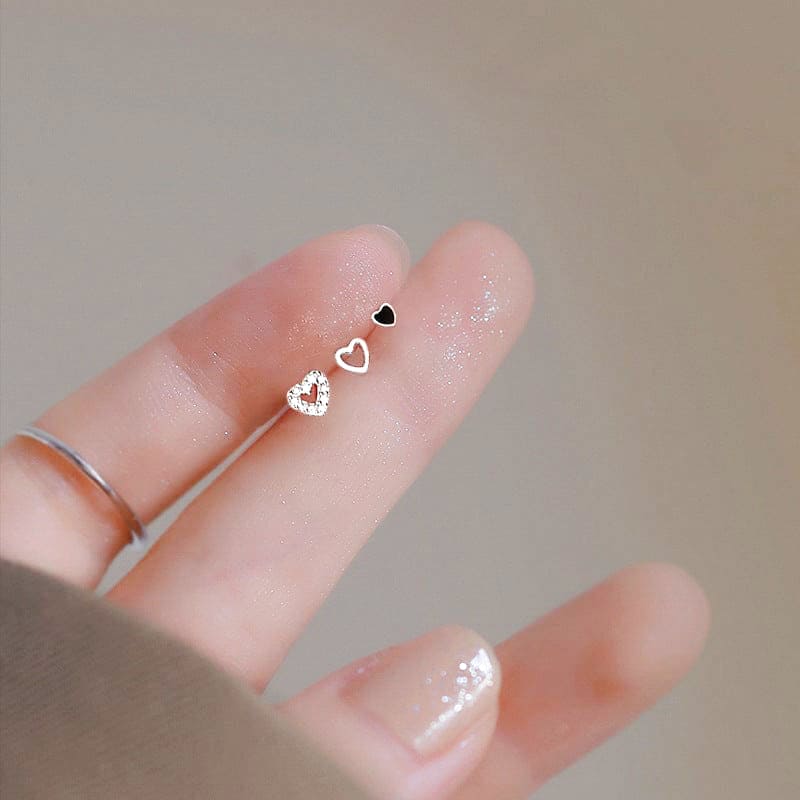 woman wearing woman holding nolo cute dainty small tiny stud cubic zirconia set of three hollow and solid different style mix and match sterling silver heart stud earrings