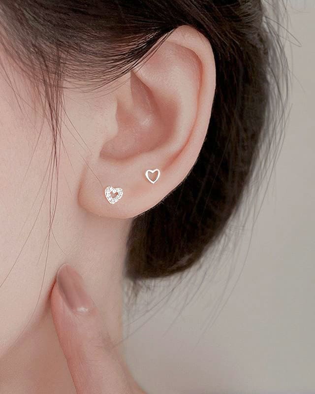 woman wearing woman holding nolo cute dainty small tiny stud cubic zirconia set of three hollow and solid different style mix and match sterling silver heart stud earrings