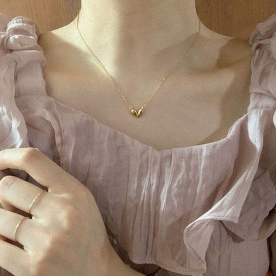 woman wearing nolo cute asymmetrical heart shape angular artistic creative style dainty irregular minimalist chain 18k gold plated sterling silver necklace