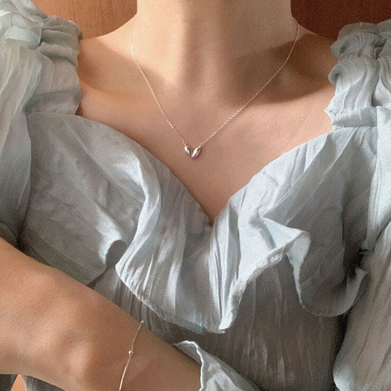 woman wearing nolo cute asymmetrical heart shape angular artistic creative style dainty irregular minimalist chain sterling silver necklace