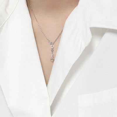 woman wearing nolo love letter heart vertical love spelling word silver rhodium plated dainty unique necklace