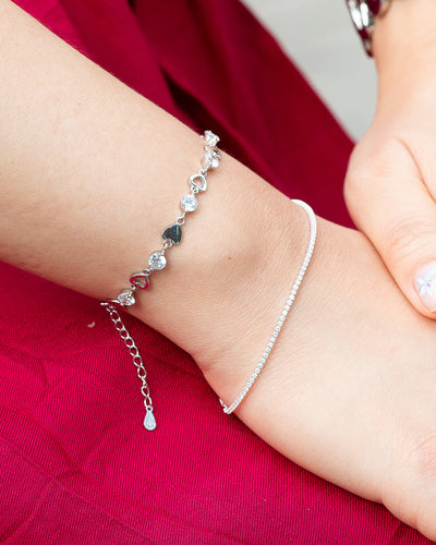 woman wearing nolo petite glimmer 1mm micro set sterling silver cubic zirconia gemstone dainty tennis bracelet