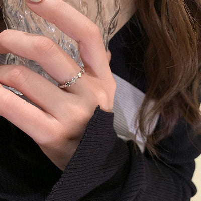 woman wearing nolo stackable dainty multi heart silver ring