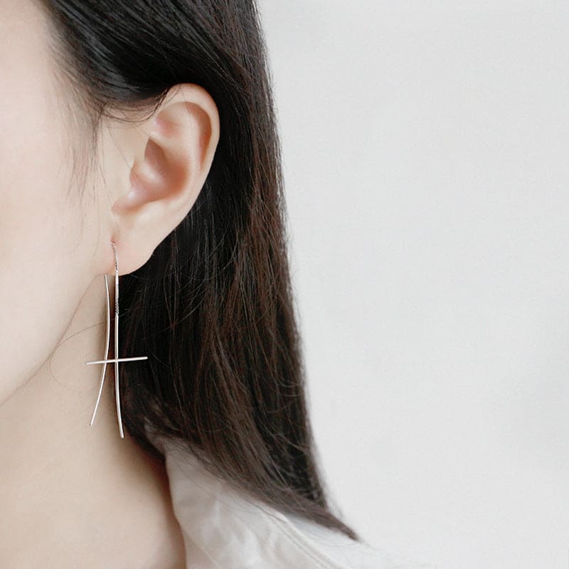 woman wearing nolo threader cross thin minimalist retro fine dangle curve long hanging chain sterling silver earrings