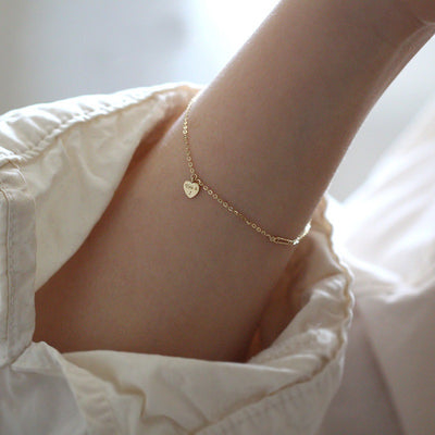 woman wearing you and I bracelet or anklet gold plated sterling silver heart chain bracelet