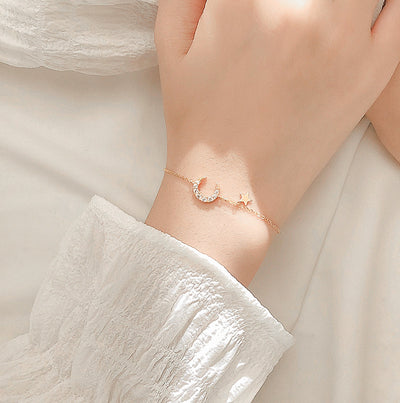 Woman Wearing Dainty Crescent Moon And Star Cubic Zirconia Gold Plated Sterling Silver Bracelet