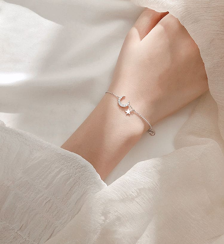 Woman Wearing Dainty Crescent Moon And Star Cubic Zirconia Sterling Silver Bracelet