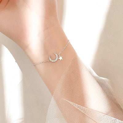 Woman Wearing Dainty Crescent Moon And Star Cubic Zirconia Sterling Silver Bracelet
