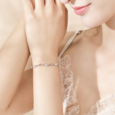 Woman Wearing Elegant Round White Gemstone Eternity Sterling Silver Women's Bracelet