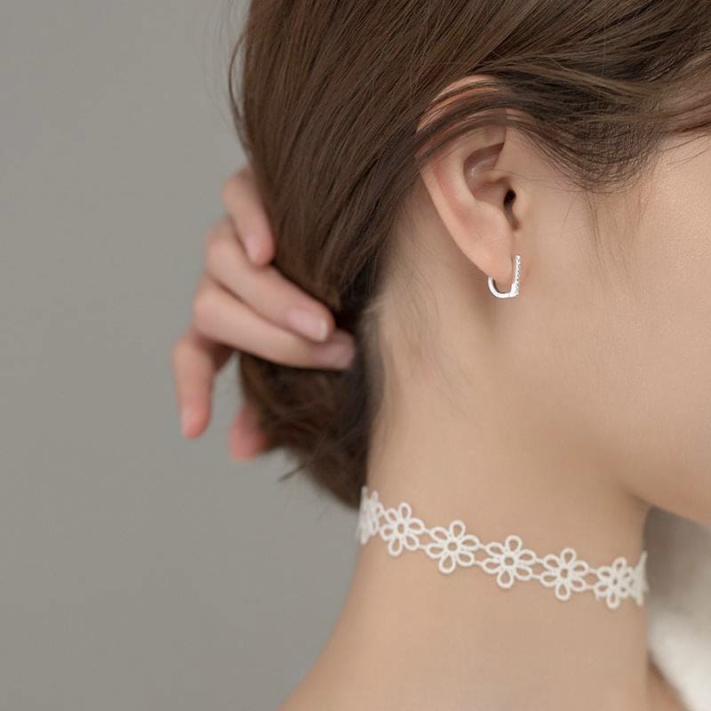 Woman Wearing Flat Bar D Shape Small Huggie Luxurious Sterling Silver Cubic Zirconia Earrings