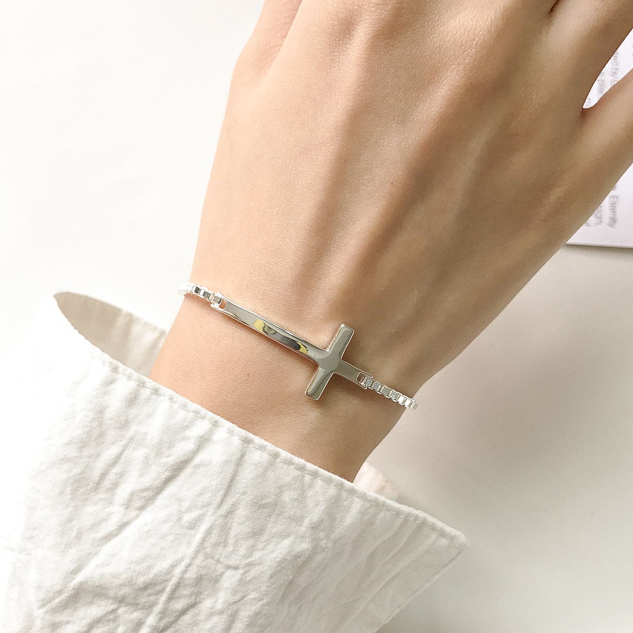 Woman Wearing Venetian Link Sterling Silver Cross Box Chain Bracelet