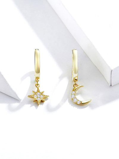 gold plated moon and star earrings set on table