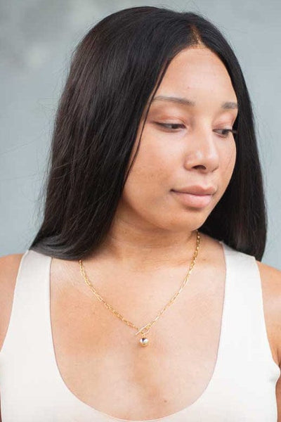 woman wearing 18k gold plated silver cable link and ball pendant lariat chain necklace