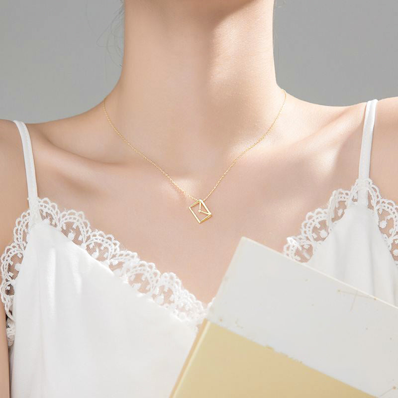 woman wearing clever dainty envelope letter 925 sterling silver cubic zirconia 18k gold plated necklace