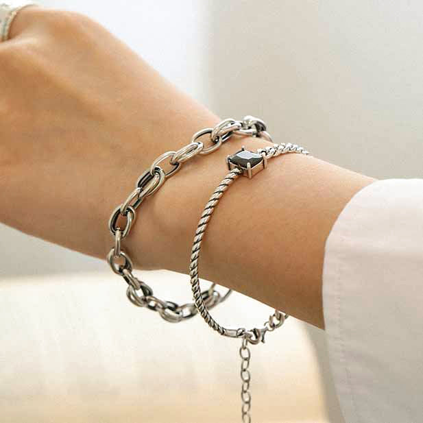woman wearing half rope link and cuban chain link black gemstone solid 925 sterling silver bracelet