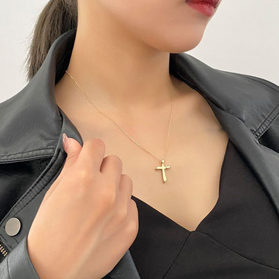 woman wearing liquid metal 18K gold plate 925 sterling silver white rhodium cross minimal necklace