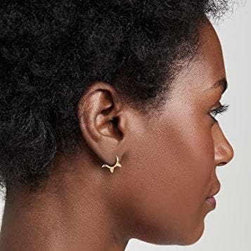 woman wearing nolo 3 spike gold plated sterling silver huggie clicker earrings