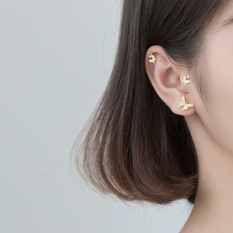 woman wearing nolo butterfly zone variety 18k gold plated sterling silver stud earrings