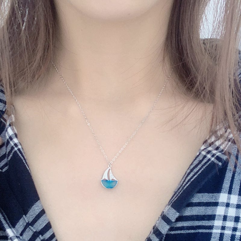 woman wearing nolo candy blue stone crystal water sailboat sterling silver necklace