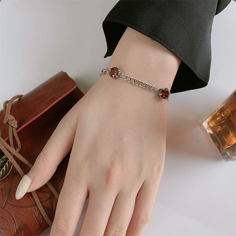 woman wearing nolo cubana rose single and double link cuban chain link sterling silver red cubic zirconia adjustable bracelet