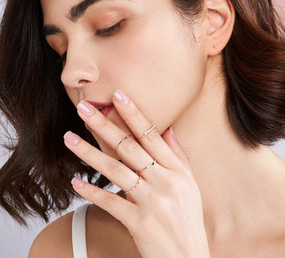 woman wearing nolo dainty stacker solid 14k gold thin minimal 2mm plain stackable ring