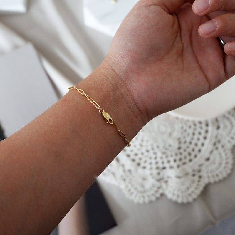 woman wearing nolo ines paper clip gold plated sterling silver bracelet
