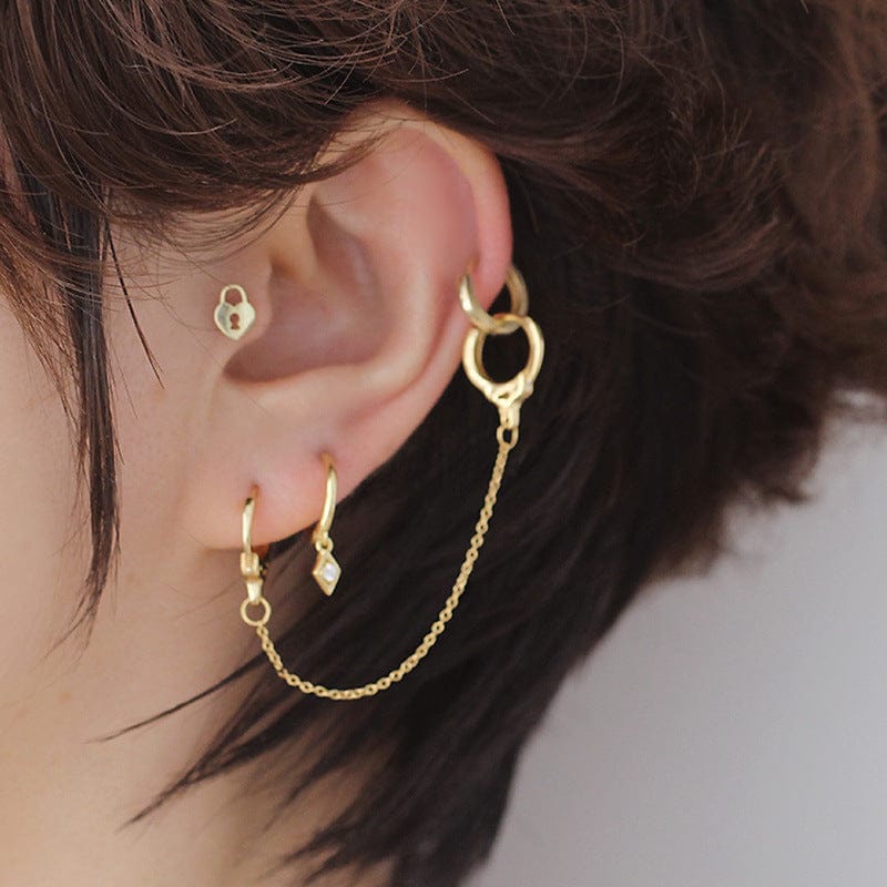 woman wearing nolo jewelry double piercing gold plated sterling silver huggie hoop earring