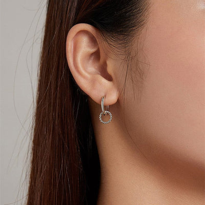 woman wearing nolo nemo 925 sterling silver unique spiral loop huggie earrings