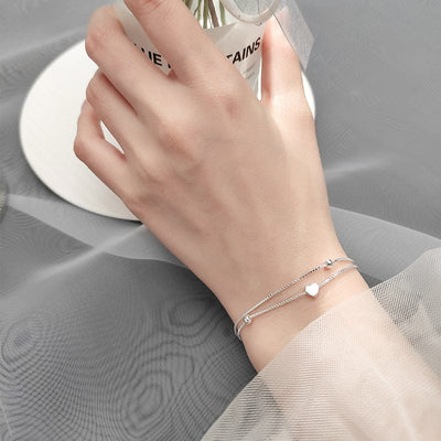 woman wearing nolo sliding heart double layer sterling silver dainty venetian link chain bracelet