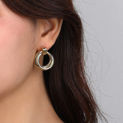 woman wearing nolo two circles double loop sterling silver 18k gold plated bold earrings