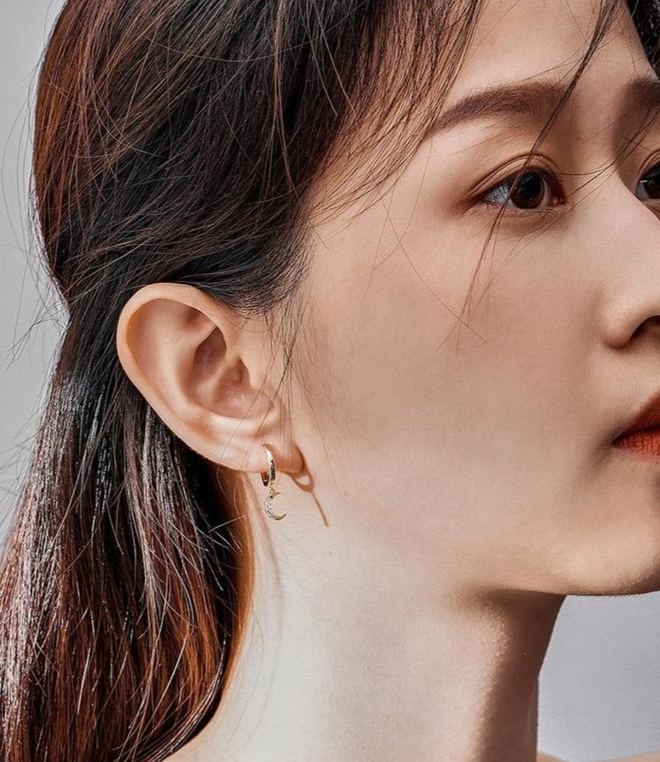 woman gold plated wearing moon earring