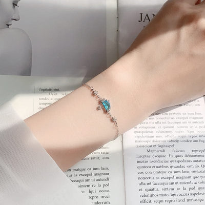 woman wearing nolo candy blue stone crystal water umbrella and sun sterling silver bracelet